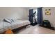 Comfortable bedroom includes large bed, exercise equipment, and window with dark curtains at 2259 King Johns Ct, Winter Park, FL 32792