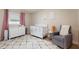 Bedroom provides crib, dresser, accent chair and rug in comfortably lit space at 2259 King Johns Ct, Winter Park, FL 32792