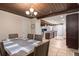 Open dining room transitions seamlessly to kitchen, offering modern appliances and connecting living spaces under rich, stained wood ceilings at 2259 King Johns Ct, Winter Park, FL 32792