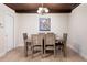 Inviting dining room features wood-style table with seating for six under decorative chandelier and wood-stained ceiling at 2259 King Johns Ct, Winter Park, FL 32792