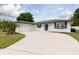 Beautiful single-story home featuring a freshly painted exterior, a well-kept lawn, and an attached garage at 2259 King Johns Ct, Winter Park, FL 32792
