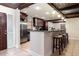 Beautiful kitchen showcasing stainless steel appliances, a granite countertop bar, and dark wood cabinetry at 2259 King Johns Ct, Winter Park, FL 32792