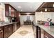 Stunning kitchen with stainless steel appliances, granite countertops, and seamless flow into the dining area at 2259 King Johns Ct, Winter Park, FL 32792