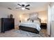 Main bedroom offers ceiling fan, large bed, window, chest-of-drawers, and neutral color palette at 2259 King Johns Ct, Winter Park, FL 32792