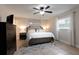 Primary bedroom shows ceiling fan, large bed, window, chest-of-drawers, and neutral color palette at 2259 King Johns Ct, Winter Park, FL 32792