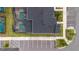 Aerial view of modern townhomes featuring a dark roof, parking, and landscaping at 2400 Reading Trl, Kissimmee, FL 34746