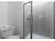 Modern bathroom features a glass-enclosed shower with tiled walls, sleek fixtures, and a toilet with fresh towels at 2400 Reading Trl, Kissimmee, FL 34746