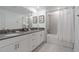 Bright bathroom featuring double sinks, a gray countertop, and a shower-tub combination at 2400 Reading Trl, Kissimmee, FL 34746