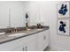 Modern bathroom with a double vanity, gray countertop, stylish fixtures, and decorative wall art for an elegant touch at 2400 Reading Trl, Kissimmee, FL 34746