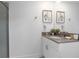 Well-lit bathroom featuring a modern vanity and a walk-in glass enclosed shower at 2400 Reading Trl, Kissimmee, FL 34746