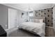 Well lit bedroom featuring an accent wall and a plush king-size bed at 2400 Reading Trl, Kissimmee, FL 34746
