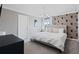 This primary bedroom boasts a statement wallpaper, king bed, and stylish lighting at 2400 Reading Trl, Kissimmee, FL 34746
