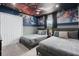Marvel-themed bedroom featuring two beds, custom wall decor and murals, and a playful superhero-themed ceiling at 2400 Reading Trl, Kissimmee, FL 34746