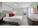Bedroom featuring a comfortable bed, themed wallpaper, and a modern television at 2400 Reading Trl, Kissimmee, FL 34746