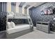 Modern bedroom with bunk beds, geometric wall design, and a TV, perfect for relaxing and entertaining at 2400 Reading Trl, Kissimmee, FL 34746