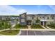Modern two-story townhome featuring contemporary design, a well-manicured landscape, and convenient parking at 2400 Reading Trl, Kissimmee, FL 34746