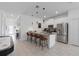 Bright kitchen with an island, stainless appliances, tile floors, and open to living area at 2400 Reading Trl, Kissimmee, FL 34746