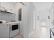 Well-equipped laundry room featuring a washer, dryer, and shelving for storage at 2400 Reading Trl, Kissimmee, FL 34746