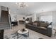 Spacious living room showcases a large leather sofa, pool table, breakfast bar and modern kitchen with stainless steel appliances at 2400 Reading Trl, Kissimmee, FL 34746