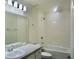 A bathroom featuring a shower-tub combo and granite countertop vanity with wood laminate flooring at 2607 Tulip Dr, Davenport, FL 33837