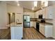 Bright kitchen features white cabinets, granite counters, island, and stainless steel appliances at 2607 Tulip Dr, Davenport, FL 33837