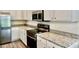 A lovely kitchen features granite countertops, stainless steel appliances and ample storage at 2607 Tulip Dr, Davenport, FL 33837