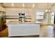A kitchen with stainless steel appliances, a granite countertop island and wood laminate flooring at 2607 Tulip Dr, Davenport, FL 33837