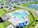 Aerial view of a community pool and playground in a neighborhood with lush greenery at 2607 Tulip Dr, Davenport, FL 33837