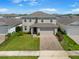 Well-manicured lawn and paved driveway enhance this two-story home's curb appeal at 2730 Parkfield Rd, St Cloud, FL 34772