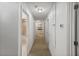 Hallway featuring neutral carpet with multiple doors and lighting fixtures at 2730 Parkfield Rd, St Cloud, FL 34772