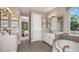 Elegant bathroom showcasing double sinks, a soaking tub, and modern finishes at 2963 Arranmore Dr, Ormond Beach, FL 32174