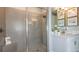 Modern bathroom featuring a glass-enclosed shower, tiled walls, and a sleek vanity at 2963 Arranmore Dr, Ormond Beach, FL 32174