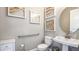 Accessible bathroom with a pedestal sink, grab bar, and framed wall art at 2963 Arranmore Dr, Ormond Beach, FL 32174