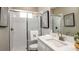 Modern bathroom with a white tiled shower and a vanity with a white countertop and chrome fixtures at 2963 Arranmore Dr, Ormond Beach, FL 32174