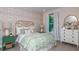 Cute bedroom featuring a unique floral wall, comfortable bed, and white furniture, creating a delightful space at 2963 Arranmore Dr, Ormond Beach, FL 32174