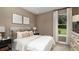 Cozy bedroom featuring neutral tones, a comfortable bed, and a window with natural light at 2963 Arranmore Dr, Ormond Beach, FL 32174