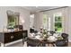 Dining area offering a table set for meals, adjacent to a buffet and a view of the modern kitchen at 2963 Arranmore Dr, Ormond Beach, FL 32174