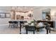 Dining area featuring seating for six, with views into modern kitchen with island and stainless steel appliances at 2963 Arranmore Dr, Ormond Beach, FL 32174