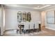 Elegant dining room featuring stylish mirrors, a modern light fixture, and seating for eight at 2963 Arranmore Dr, Ormond Beach, FL 32174