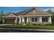 Charming single-story home featuring stone accents, a covered porch, and well-manicured lawn at 2963 Arranmore Dr, Ormond Beach, FL 32174