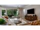 Cozy living room featuring a comfortable sofa, modern decor, and a view of the outdoors at 2963 Arranmore Dr, Ormond Beach, FL 32174