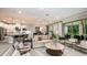 Bright, open-concept living room with a sofa, modern furnishings, and seamless flow to kitchen and outdoor space at 2963 Arranmore Dr, Ormond Beach, FL 32174