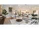 Spacious living room featuring staircase, stylish furnishings, and an open layout connecting to dining and kitchen areas at 2963 Arranmore Dr, Ormond Beach, FL 32174