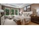 Serene primary bedroom featuring a tray ceiling, plush carpet, and large windows at 2963 Arranmore Dr, Ormond Beach, FL 32174