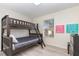 Bright bedroom featuring a wooden bunk bed, window, and cheerful wall art at 309 Verona Ave, Davenport, FL 33897