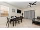 Stylish dining area with a modern table, tiled floors, and natural light from the window at 309 Verona Ave, Davenport, FL 33897