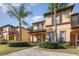 Inviting townhome exterior with manicured landscaping and brick walkway to the front door at 309 Verona Ave, Davenport, FL 33897