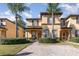 Charming townhome featuring a meticulously landscaped yard and a brick-paved walkway at 309 Verona Ave, Davenport, FL 33897