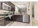 Well-equipped kitchen featuring stainless steel appliances, dark cabinetry, and granite counters at 309 Verona Ave, Davenport, FL 33897