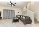 Spacious living room with tile floors, a ceiling fan, and a comfortable sectional sofa at 309 Verona Ave, Davenport, FL 33897